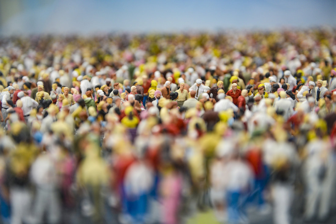 Dozens of small human figurines made to look like a crowd of people