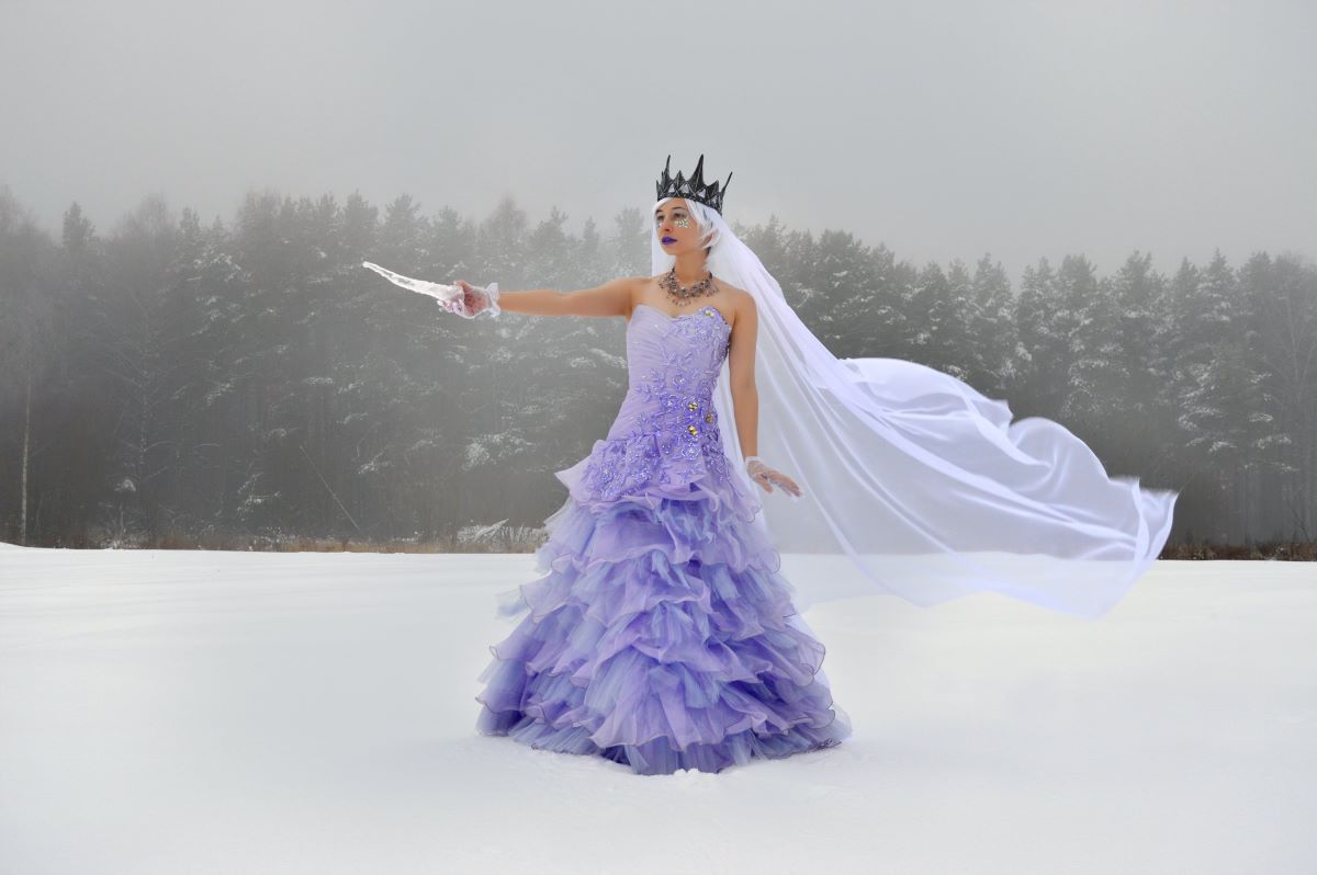 Fae queen in purple gown against a wintery landscape